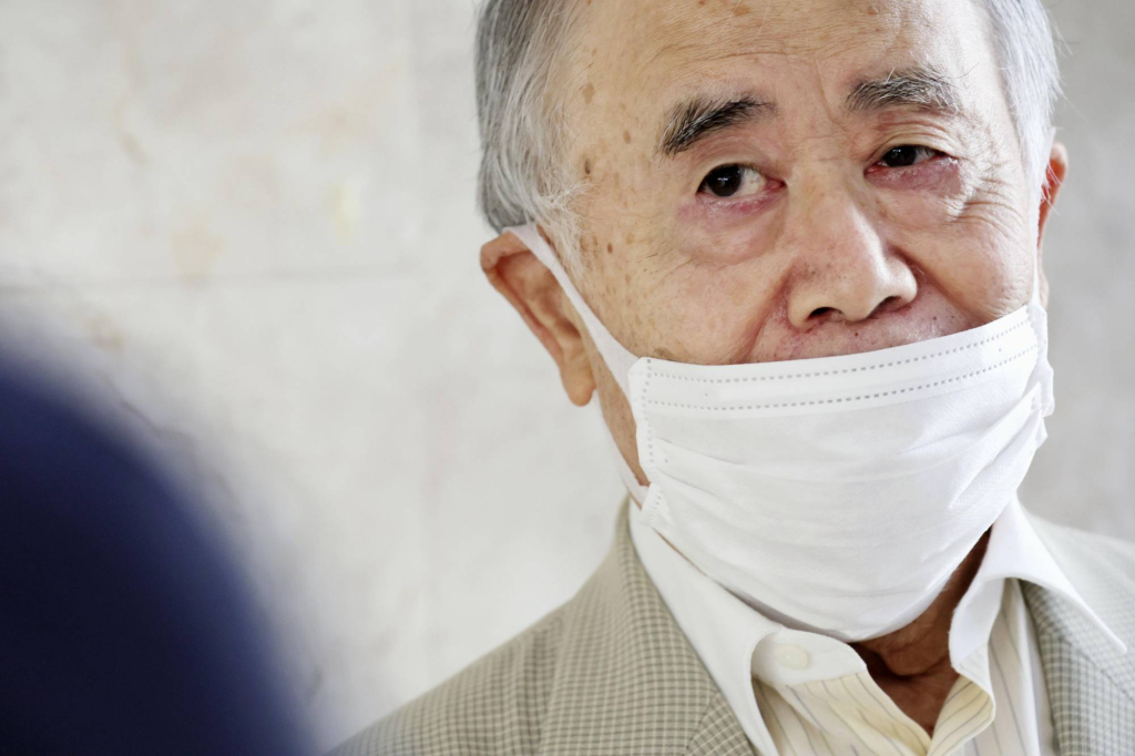 A picture of Kadokawa Chairman Tsuguhiko in a surgical mask, speaking to reporters on September 5. Picture sourced from Japan Times article dated September 14, 2022.